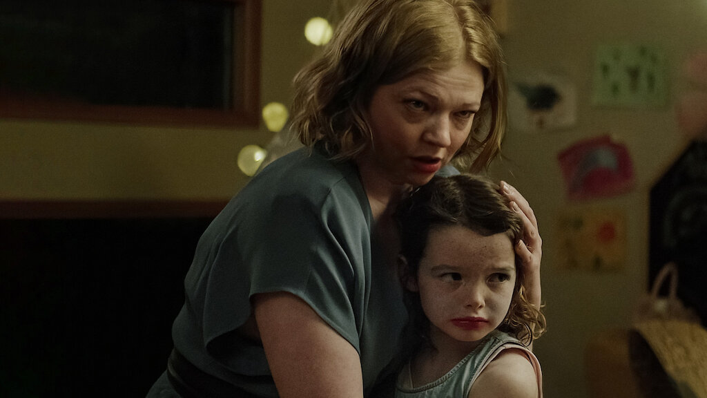An image from the film Run Rabbit Run. It features a woman (Sarah Snook) and a young child. The woman is holding the child tight to her. 