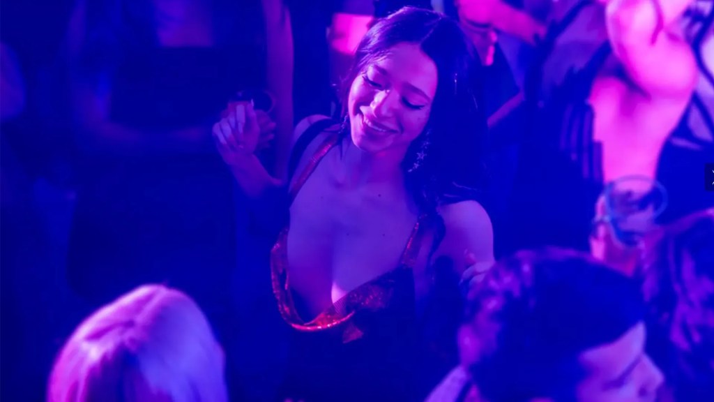 An image from the film Anora. It features a woman (Mikey Madison) dancing in a club.