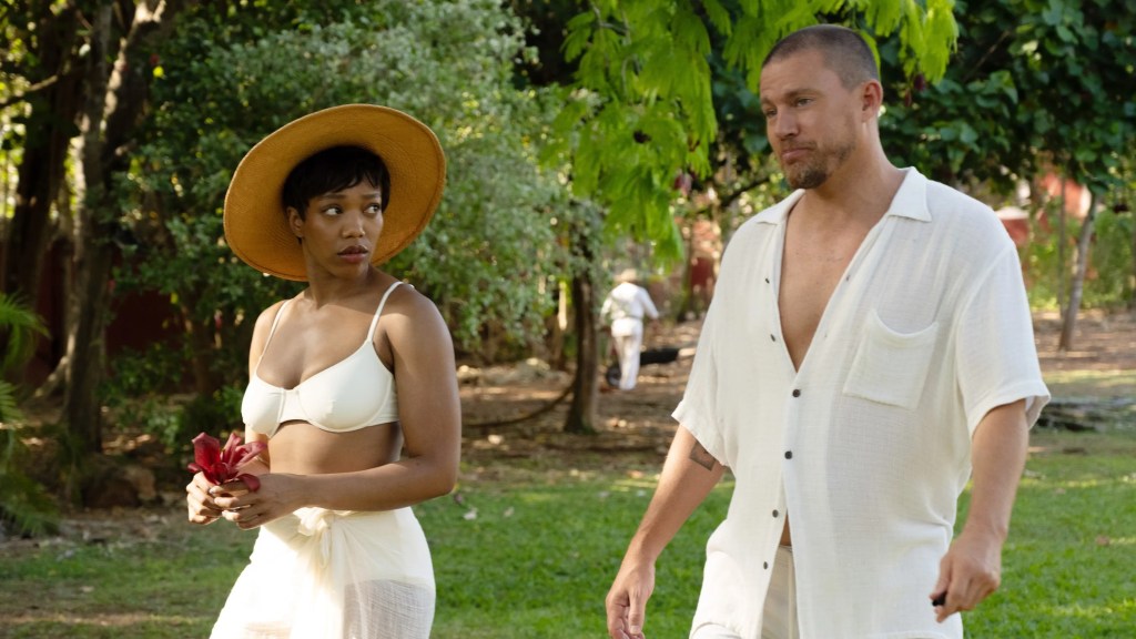 An image from the film Blink Twice. It features a man (Channing Tatum) and a woman (Naomi Ackie) walking beside each other in an island villa.