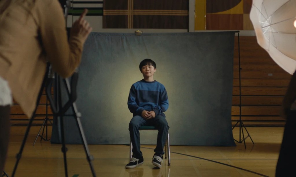 An image from the film Dìdi. It features a boy (Izaac Wang) posing for a school photograph.