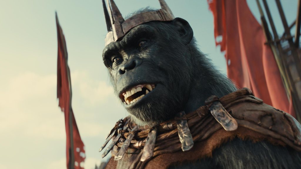 An image from the film Kingdom of the Planet of the Apes. It features an ape with a metal crown on.