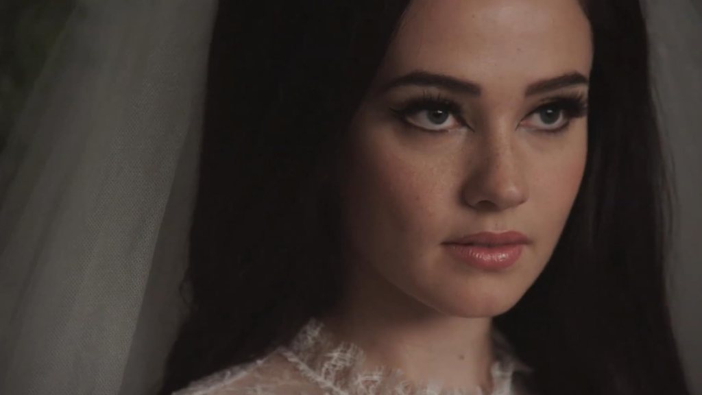 An image from the film Priscilla. It features a close up of a woman (Cailee Spaeny) wearing a wedding veil.