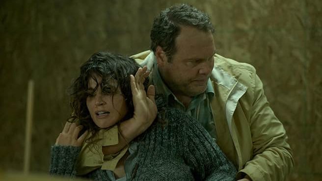 An image from the film Chained. It features a man (Vincent D'Onofrio) holding a woman (Julia Ormond) against her will.