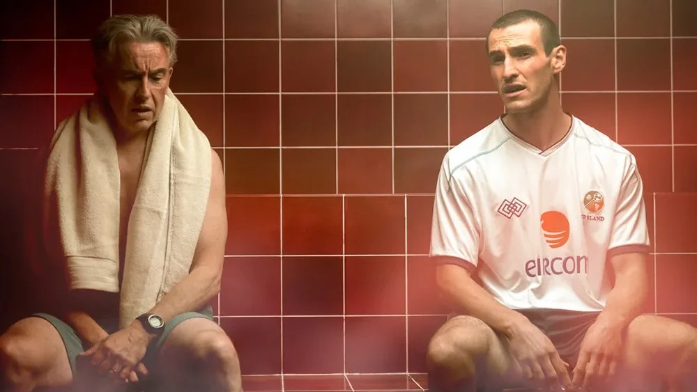 An image from the film Saipan. It features two men (Éanna Hardwicke) and (Steve Coogan) sitting in a sauna side by side.